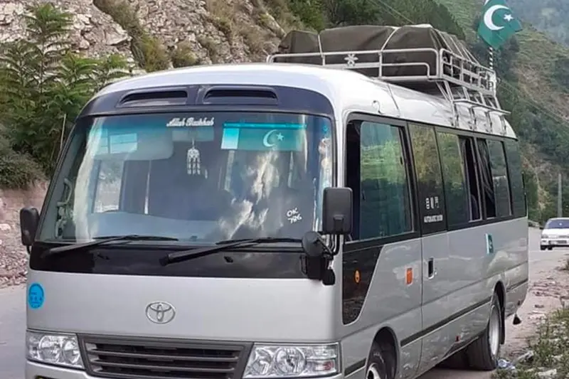 Toyota Coaster 4C Saloon executive bus available with a driver for group travel in Pakistan