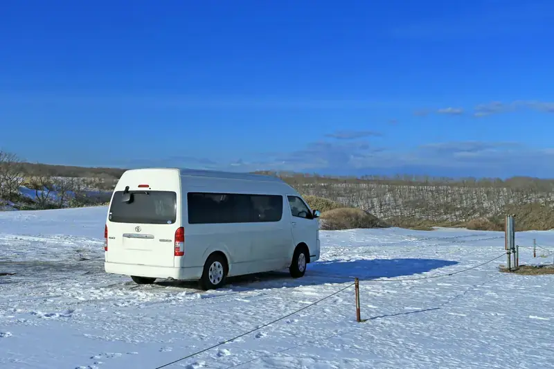 White Toyota Hiace Grand Cabin van available for group travel in Pakistan